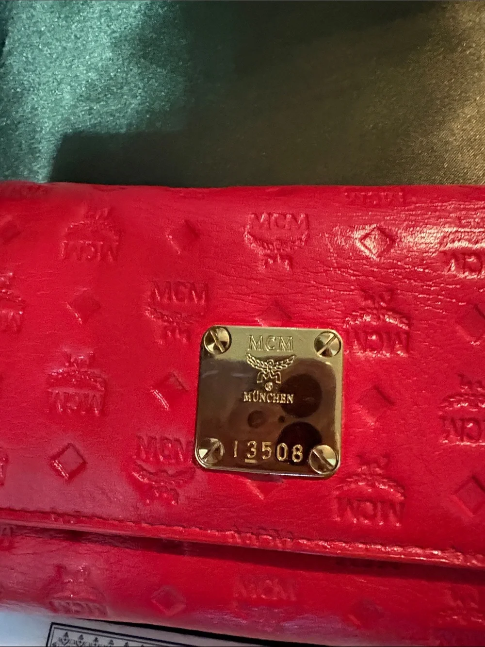 MCM Red Embossed Leather Trifold Wallet with Gold Plaque Accent